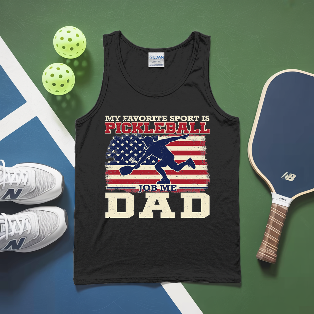 Black tank top with pickleball-themed design on a green and blue surface with pickleballs and a paddle.