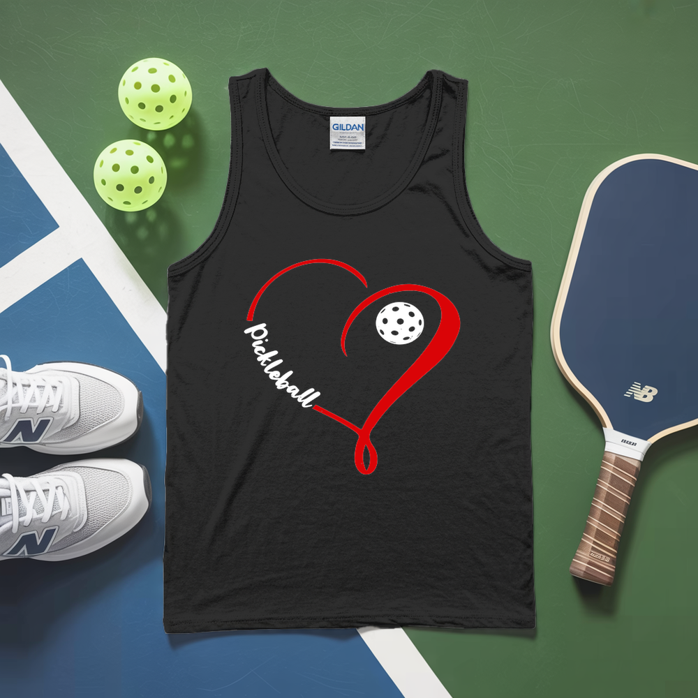 Black tank top with red heart and pickleball design, next to a paddle and balls on a green and blue surface.