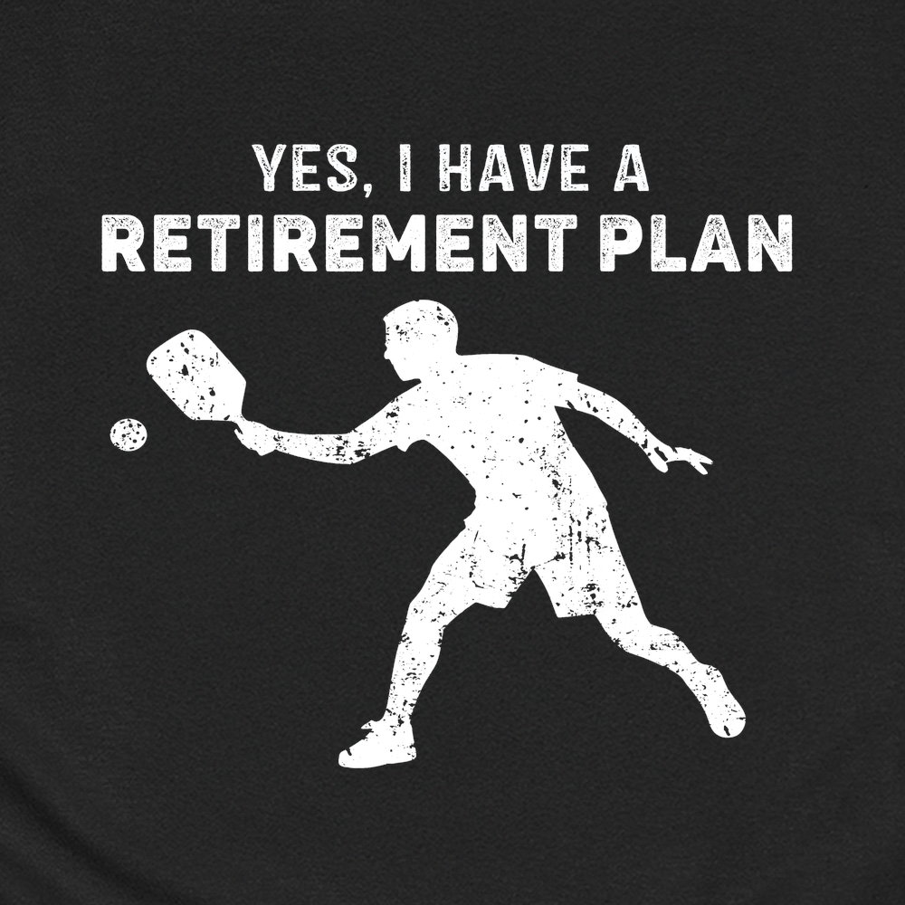 Black t-shirt with white pickleball player graphic and text 'YES, I HAVE A RETIREMENT PLAN' on a black background