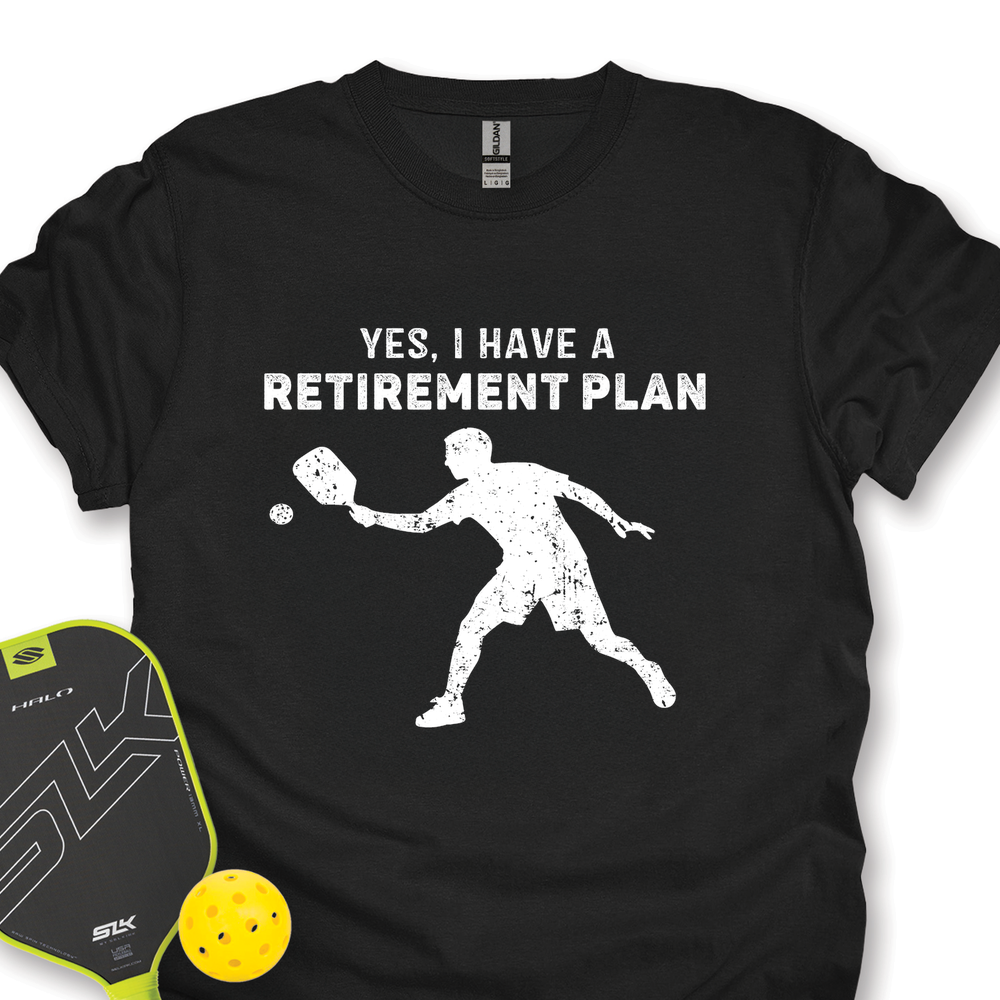 Black t-shirt with pickleball design and text 'YES, I HAVE A RETIREMENT PLAN' on a white background.