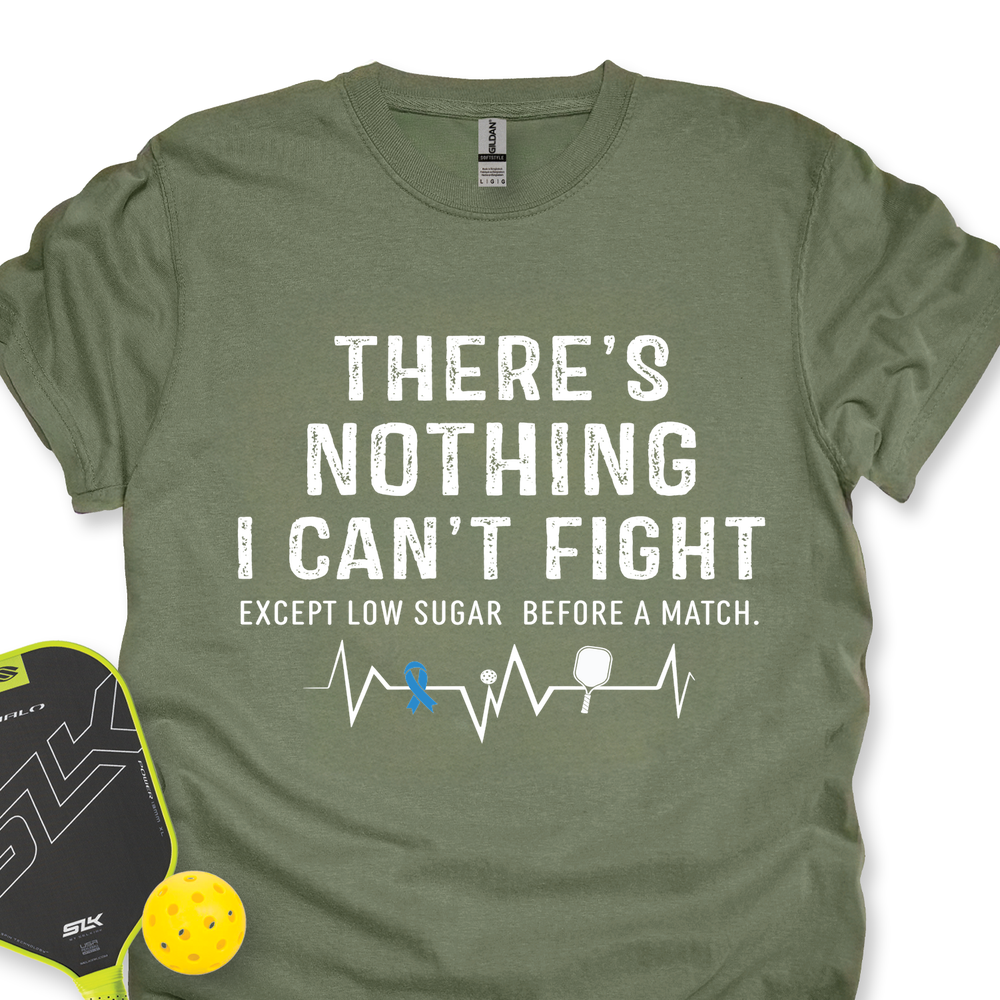 Green t-shirt with motivational quote and pickleball accessories on a white background