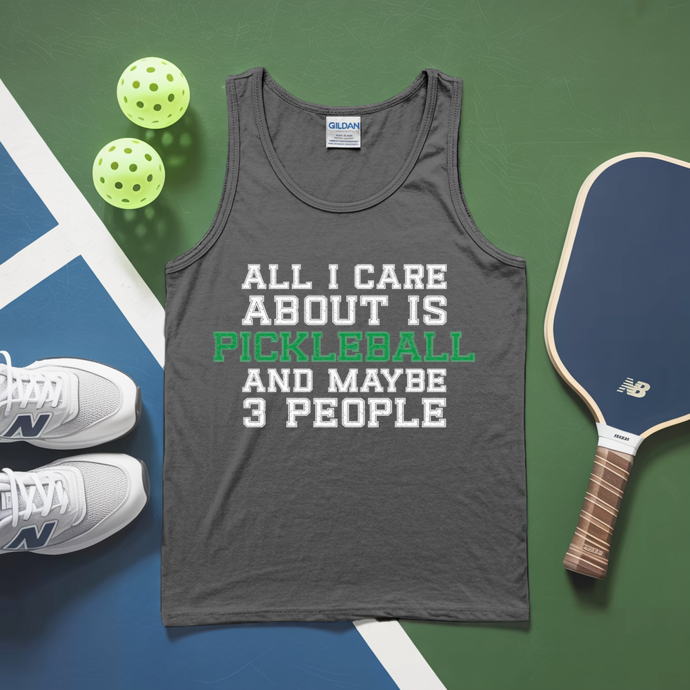 Gray tank top with pickleball text, pickleballs, and paddle on a green and blue background