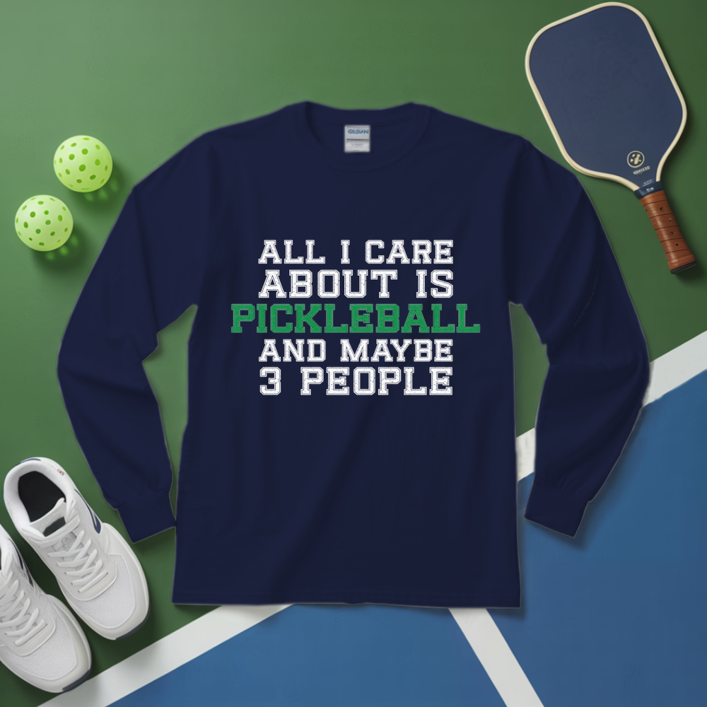 Navy blue sweatshirt with pickleball text on a green and blue surface with pickleballs and a paddle.