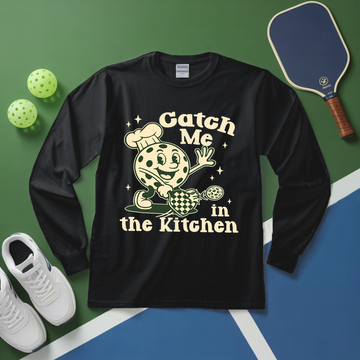 Black long-sleeve shirt with a graphic design and text on a green and blue background with sports equipment.