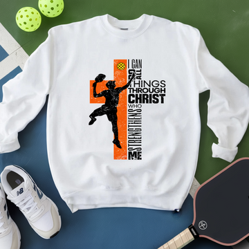 White sweatshirt with a graphic design featuring a silhouette of a person and text, placed on a green and blue surface with sports equipment.