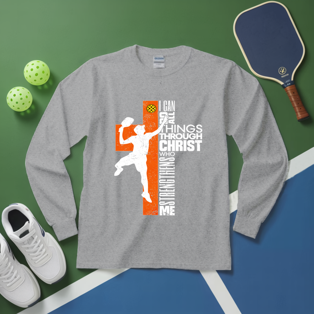 Gray long-sleeve shirt with pickleball design on a green and blue surface with pickleballs and paddle.