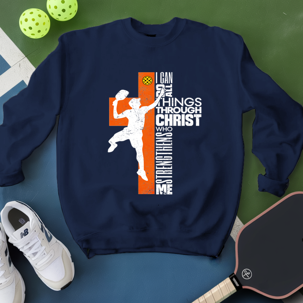 Navy blue sweatshirt with sports-themed design on a green and blue surface with sports equipment.