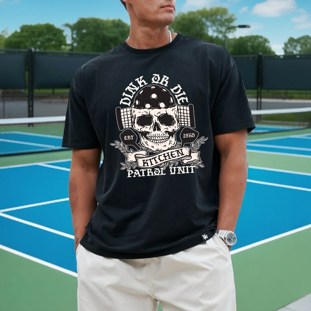 Person wearing a black t-shirt with a graphic design on a tennis court