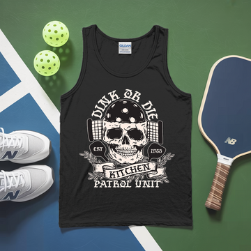 Black tank top with skull design and text, placed on a sports-themed surface with pickleball equipment.