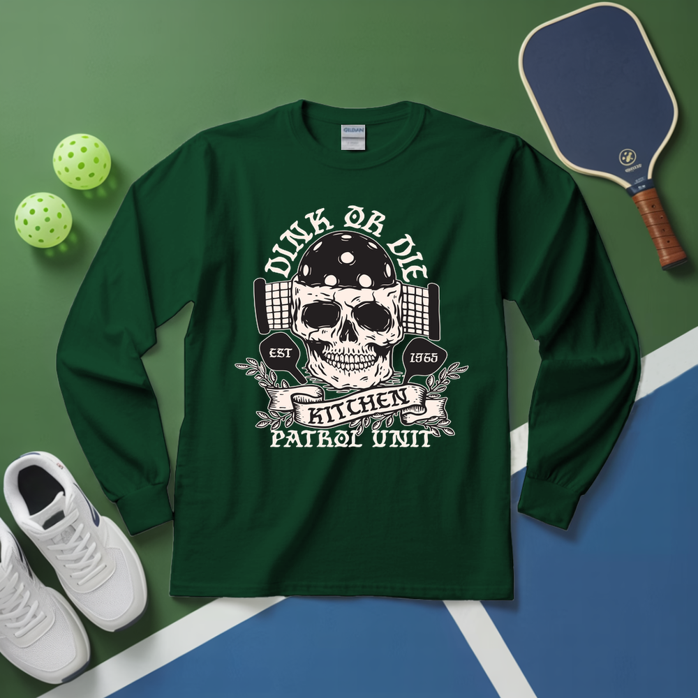 Green long-sleeve shirt with skull design on a green and blue surface with sports equipment.
