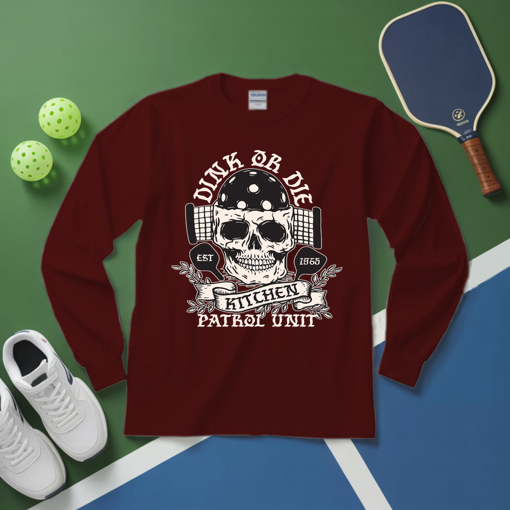 Maroon long-sleeve shirt with skull design on a green and blue surface with sports equipment.