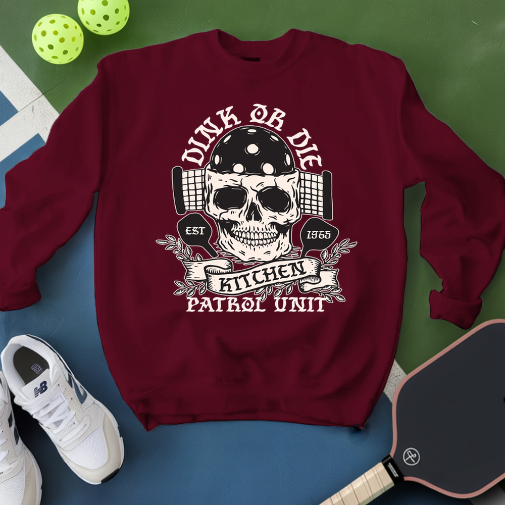 Maroon sweatshirt with skull graphic and text on a green and blue background