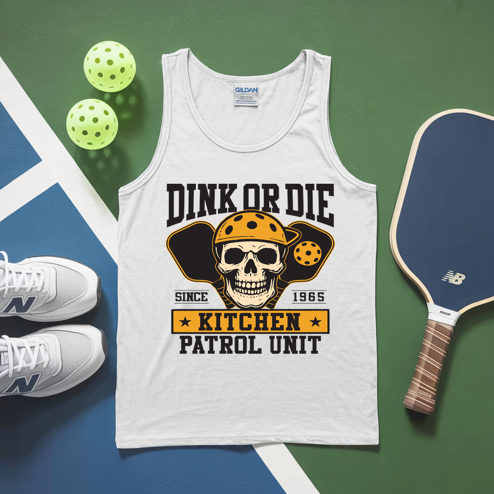 White tank top with skull graphic and text, placed on a green and blue surface with pickleballs and a paddle.