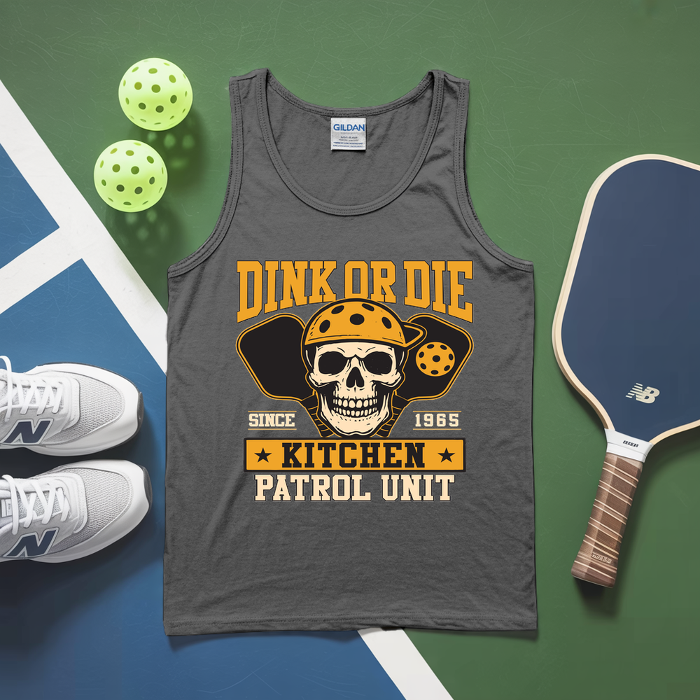 Gray tank top with skull graphic and text, placed on a green and blue surface with pickleballs and a paddle.