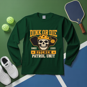Green long-sleeve shirt with skull design and text on a green and blue background with pickleball equipment.