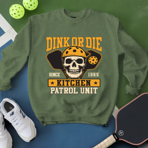 Green sweatshirt with skull graphic and text on a blue and green background
