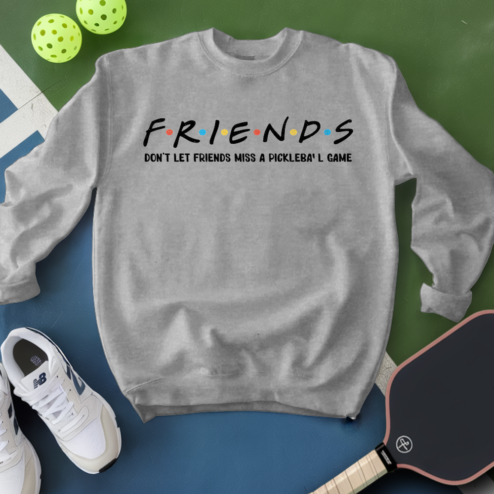 Gray sweatshirt with 'FRIENDS' text, pickleball paddles, and balls on a green and blue background
