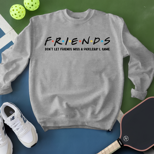 Gray sweatshirt with 'FRIENDS' text, pickleball paddles, and balls on a green and blue background
