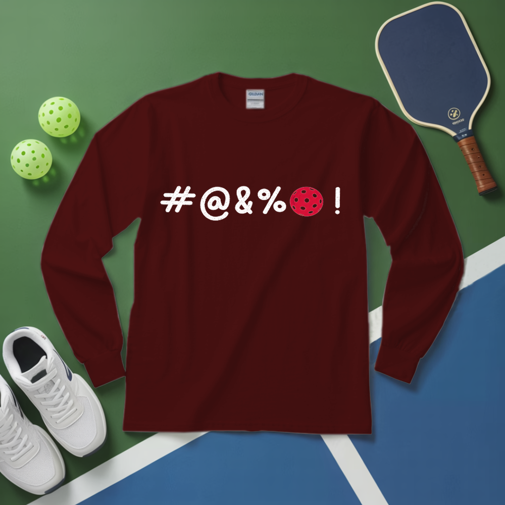 Maroon long-sleeve shirt with '#@&%' text and pickleball elements on a green and blue surface.