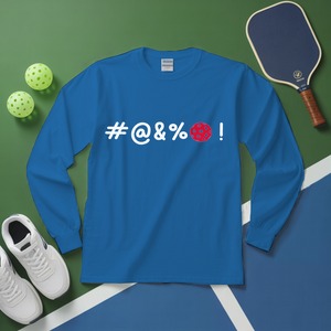 Blue long-sleeve shirt with '#@&%' text, pickleball paddle, balls, and shoes on a green and blue surface.