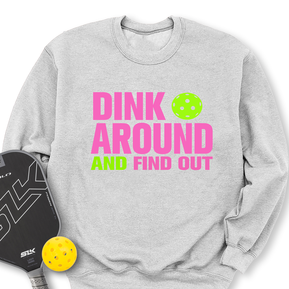 Gray sweatshirt with 'Dink Around and Find Out' text, pickleball paddle, and ball on a white background