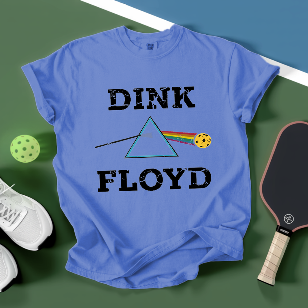 Blue t-shirt with 'Dink Floyd' design on a green background with pickleball equipment.