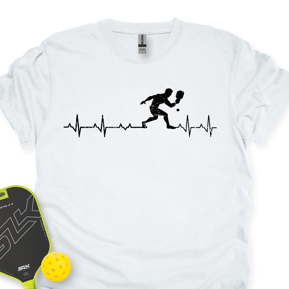White t-shirt with pickleball design and paddle and ball on a white background