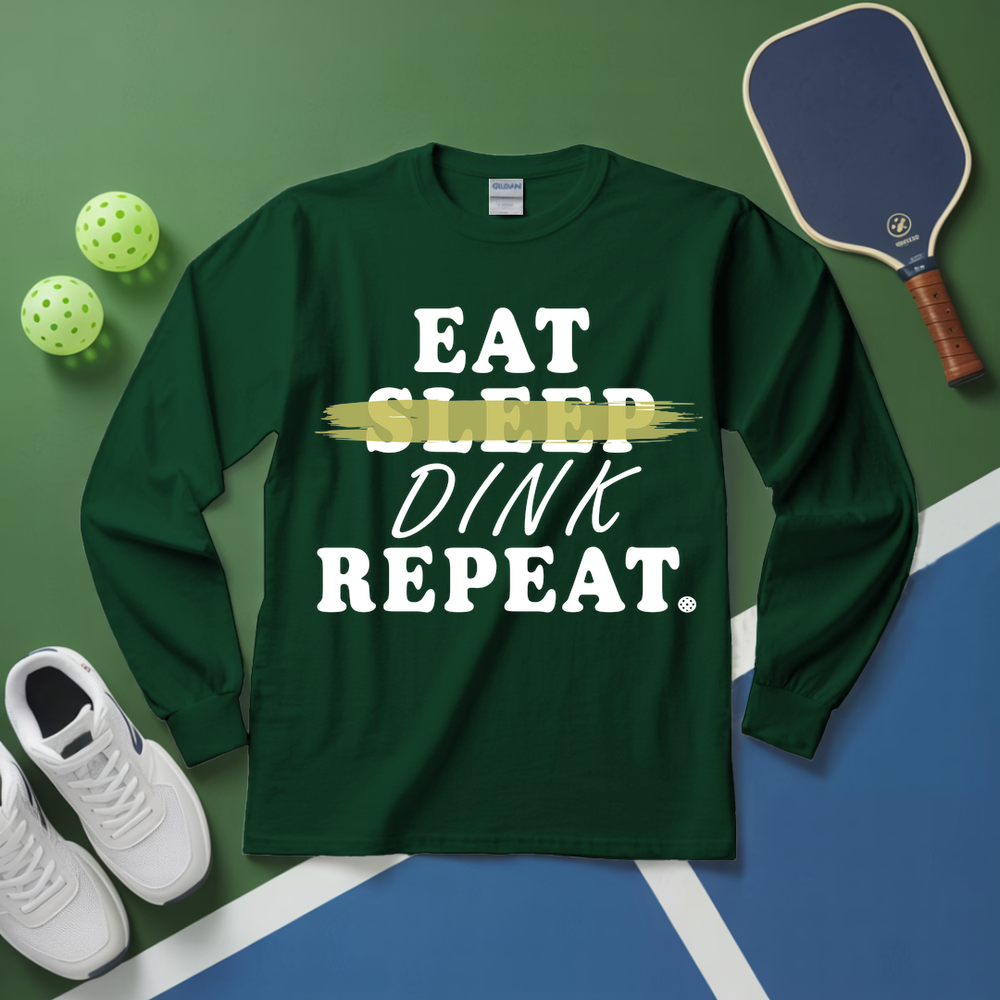 Green long-sleeve shirt with 'Eat Sleep Dink Repeat' text on a pickleball court background.