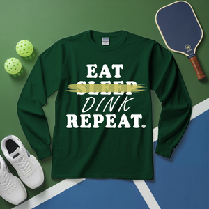 Green long-sleeve shirt with 'Eat Sleep Dink Repeat' text on a pickleball court background.