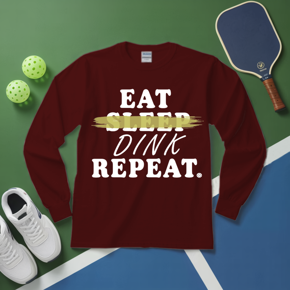Maroon long-sleeve shirt with 'Eat Sleep Dink Repeat' text on a pickleball-themed background.