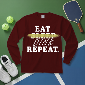 Maroon long-sleeve shirt with 'Eat Sleep Dink Repeat' text on a pickleball-themed background.