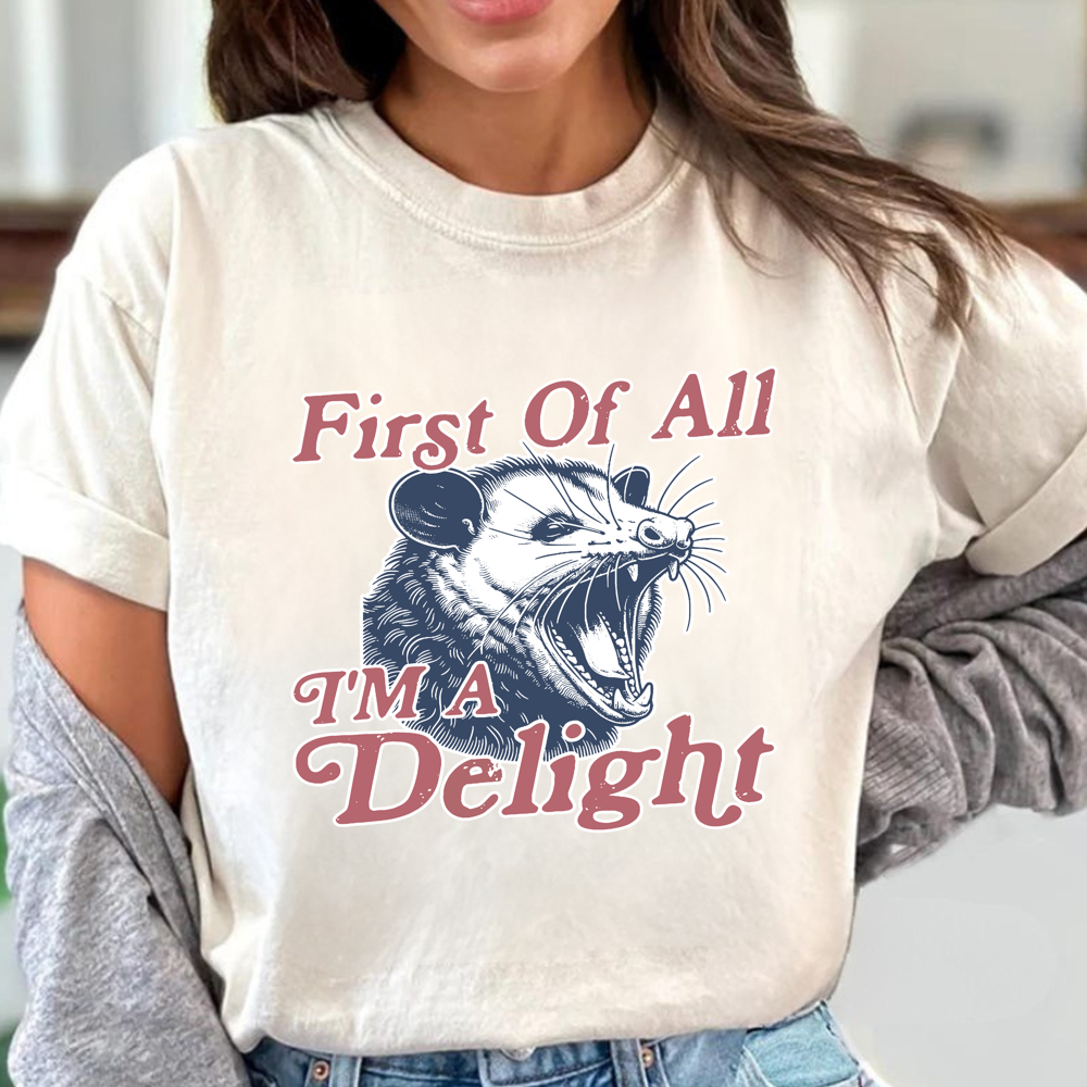 Person wearing a t-shirt with an opossum graphic and text.