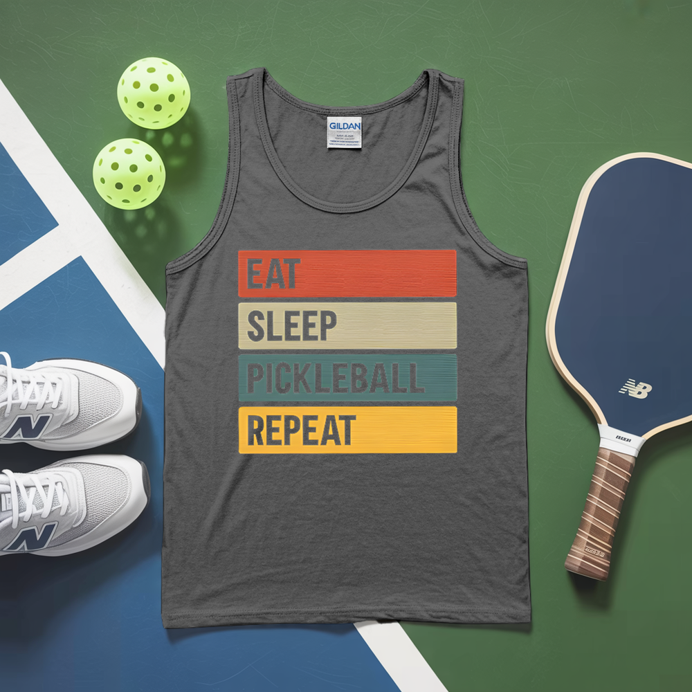 Gray tank top with 'Eat Sleep Pickleball Repeat' text, pickleball paddles, and balls on a green and blue surface.