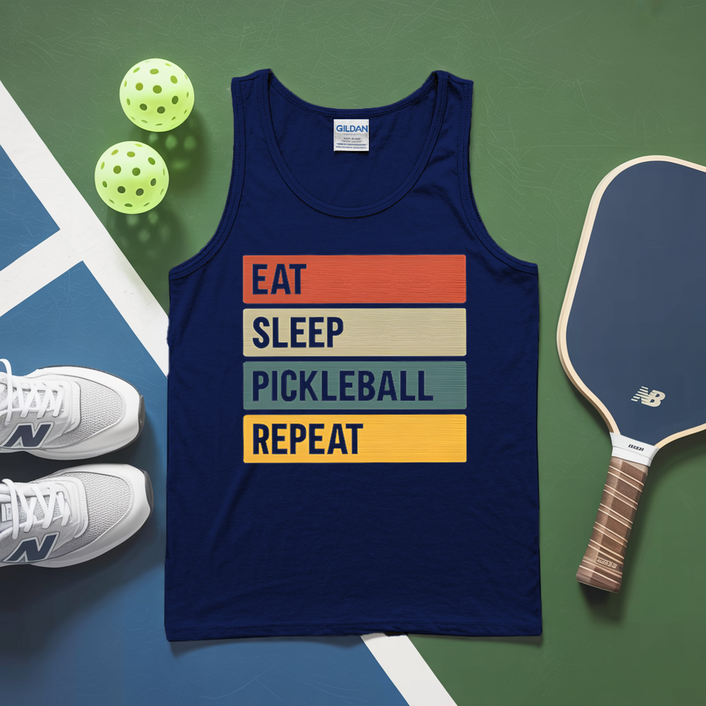 Navy tank top with 'Eat Sleep Pickleball Repeat' text on a green and blue surface with pickleballs and a paddle.