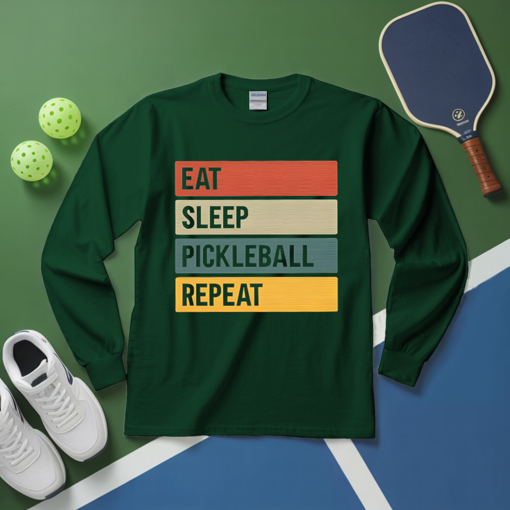 Green long-sleeve shirt with 'Eat Sleep Pickleball Repeat' text on a pickleball court background.