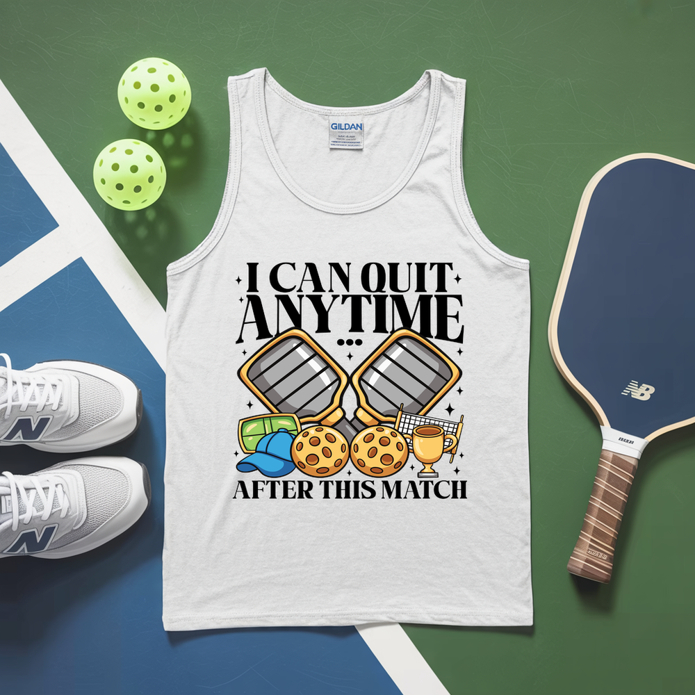 White tank top with pickleball-themed design on a green and blue surface with pickleballs and a paddle.
