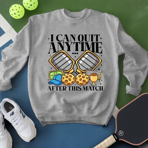 Gray sweatshirt with pickleball-themed design and text, surrounded by pickleballs and a paddle.