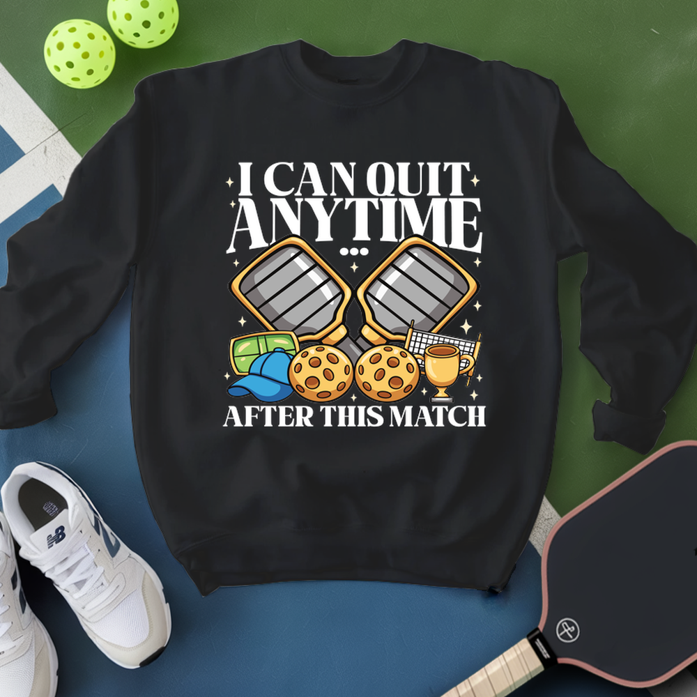 Black sweatshirt with pickleball-themed design on a blue and green background