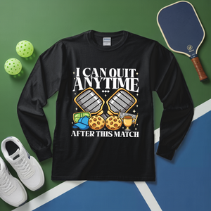 Black long-sleeve shirt with pickleball-themed design on a green and blue court background.