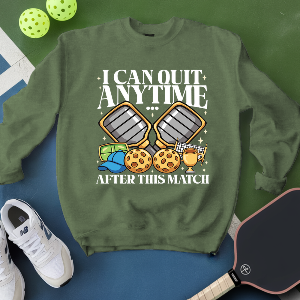 Green sweatshirt with pickleball-themed design on a blue and green background