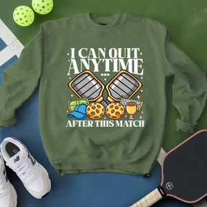 Green sweatshirt with pickleball-themed design on a blue and green background