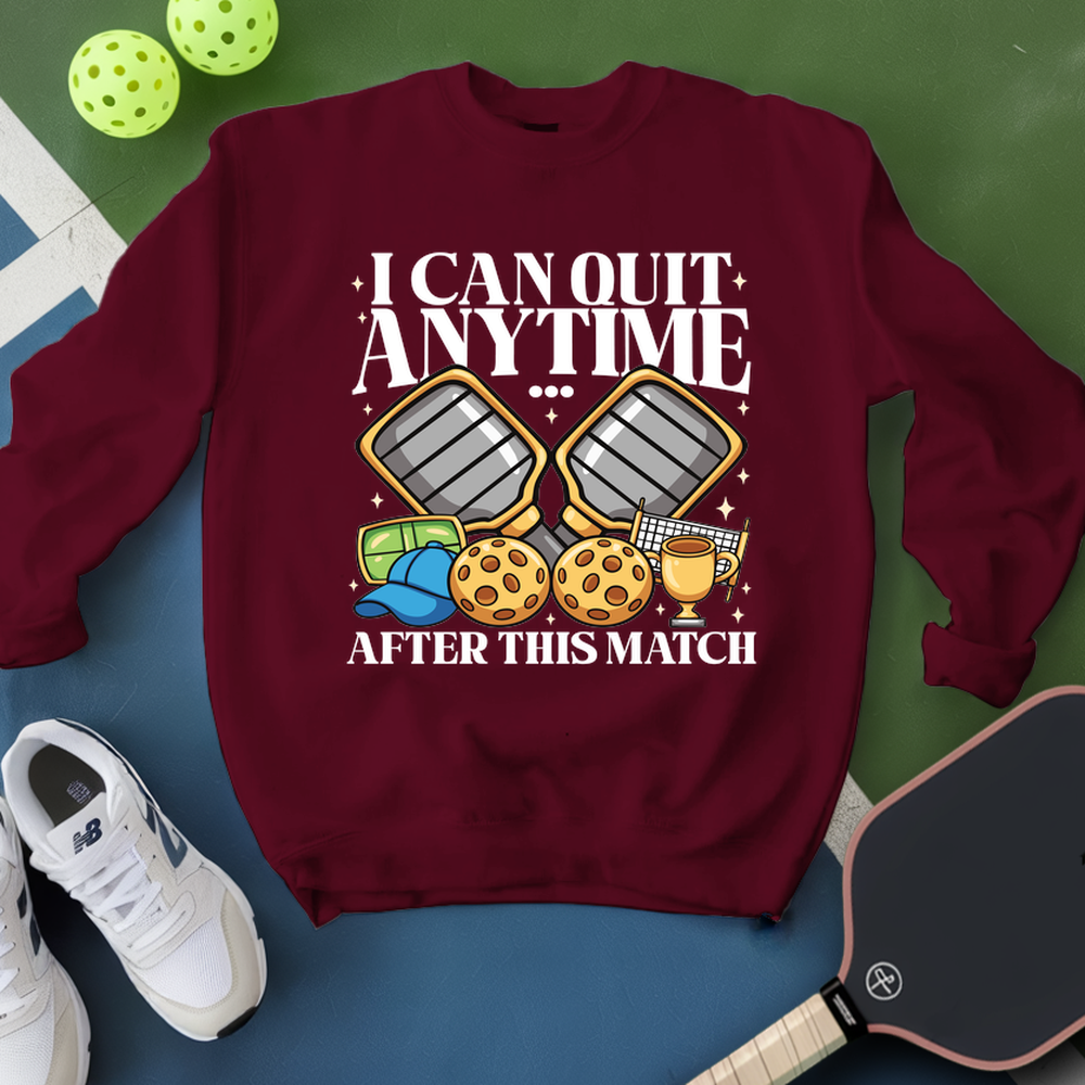 Maroon sweatshirt with pickleball-themed graphic and text on a green and blue background.