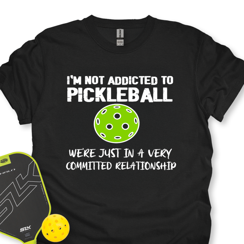 Black t-shirt with pickleball-themed text and graphics on a white background