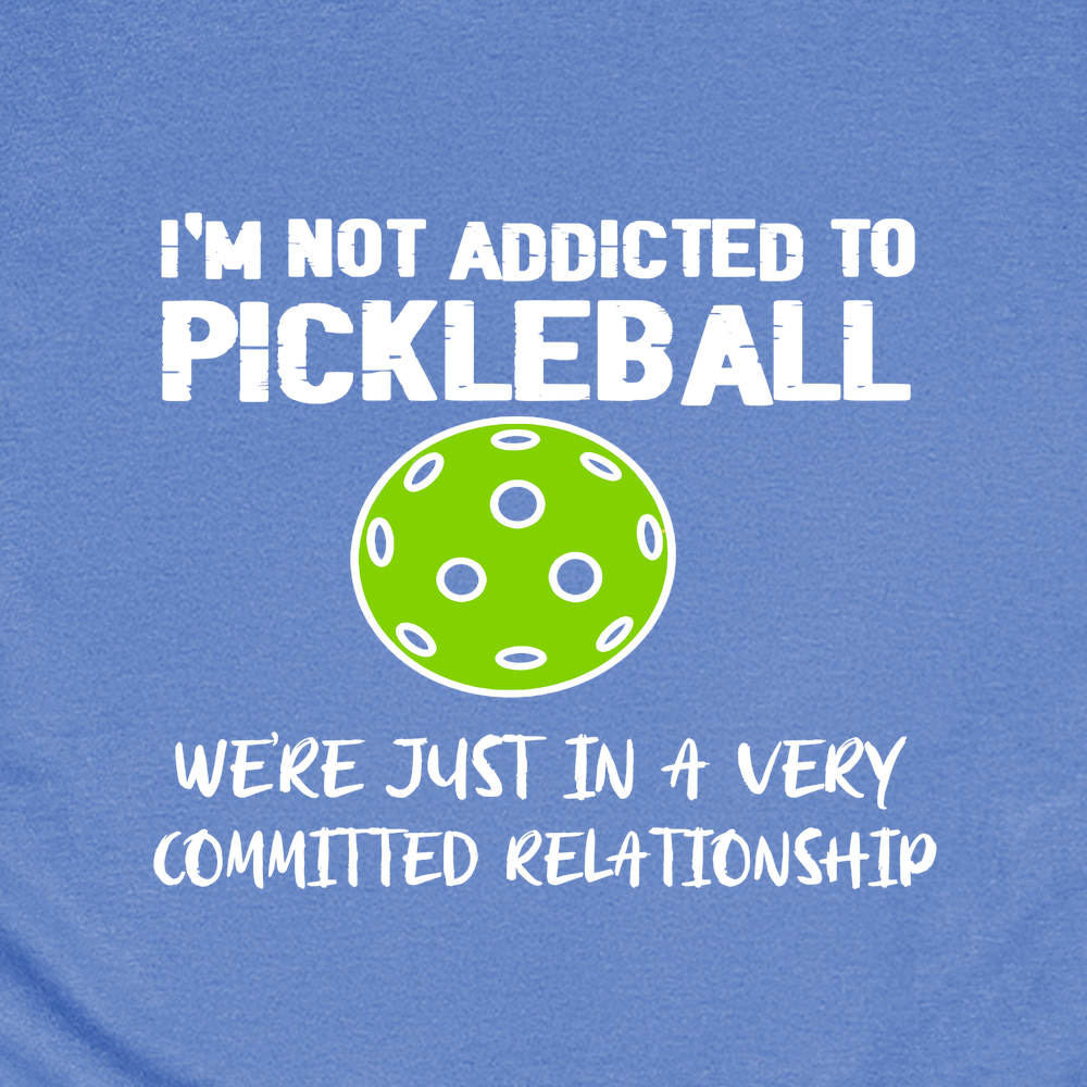 Blue t-shirt with a green pickleball graphic and humorous text on a blue background
