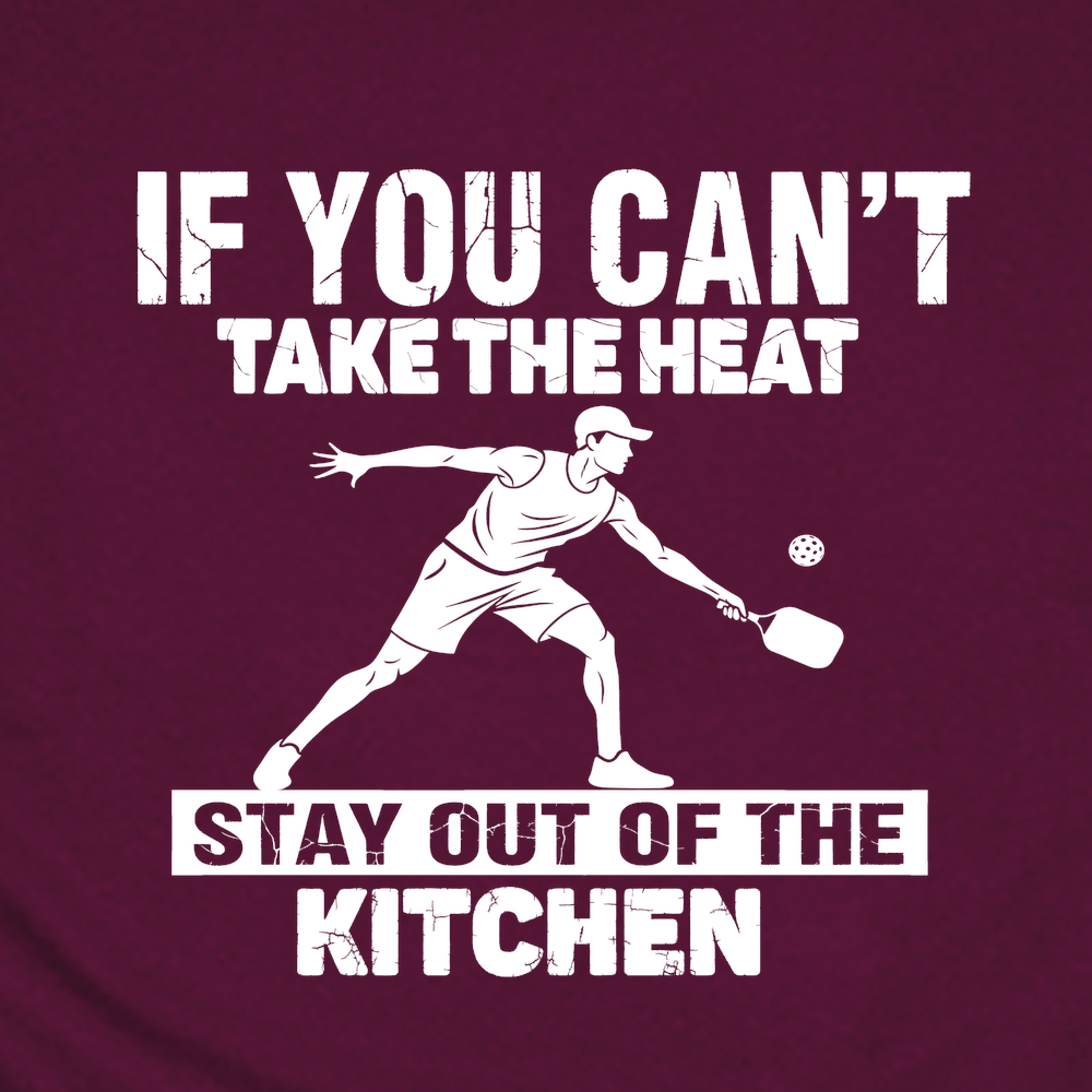 Maroon t-shirt with white text and pickleball player graphic, accompanied by a pickleball paddle and ball on a white background.