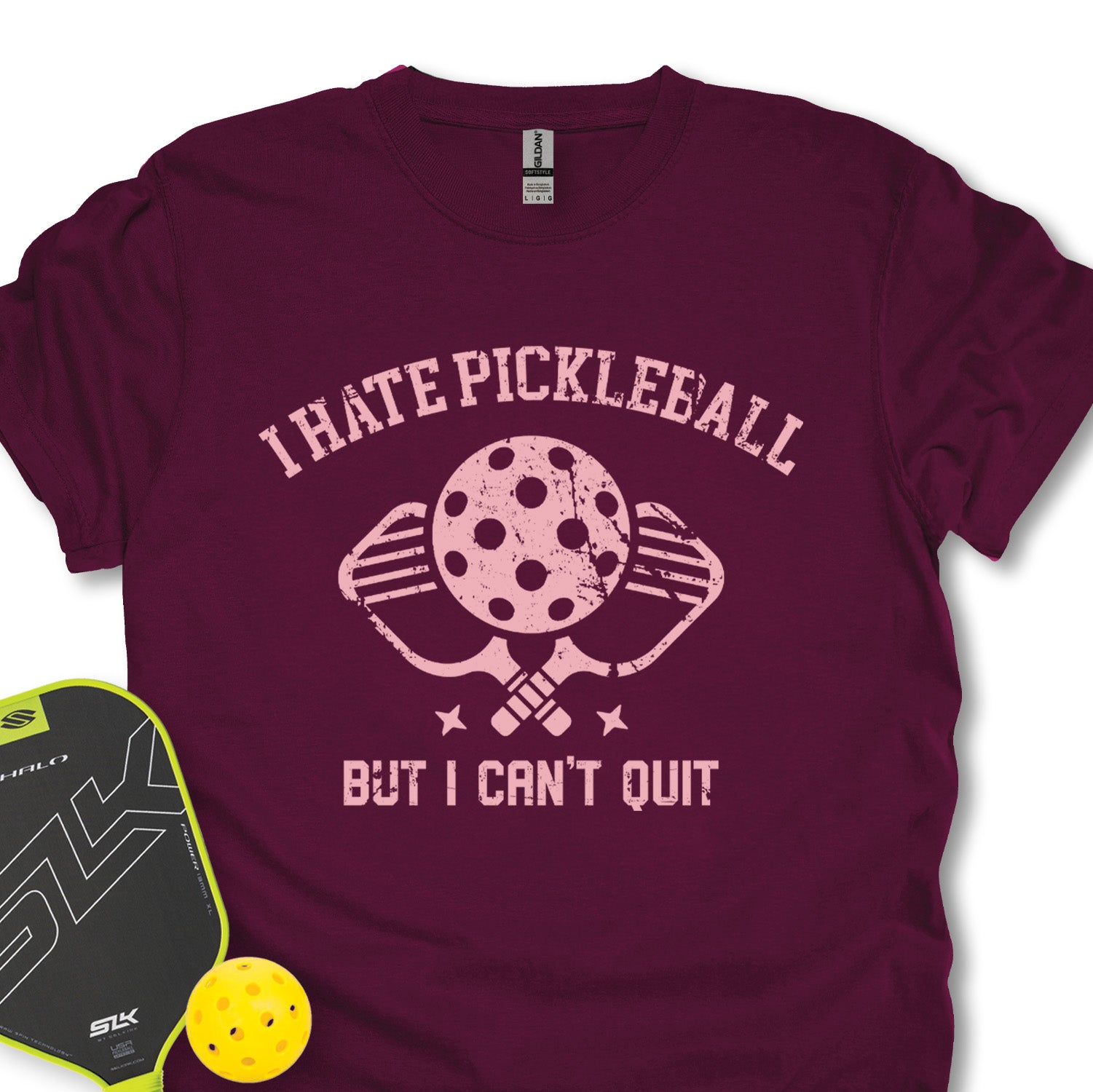 Maroon t-shirt with 'I Hate Pickleball But I Can't Quit' graphic and pickleball paddle and ball on a white background