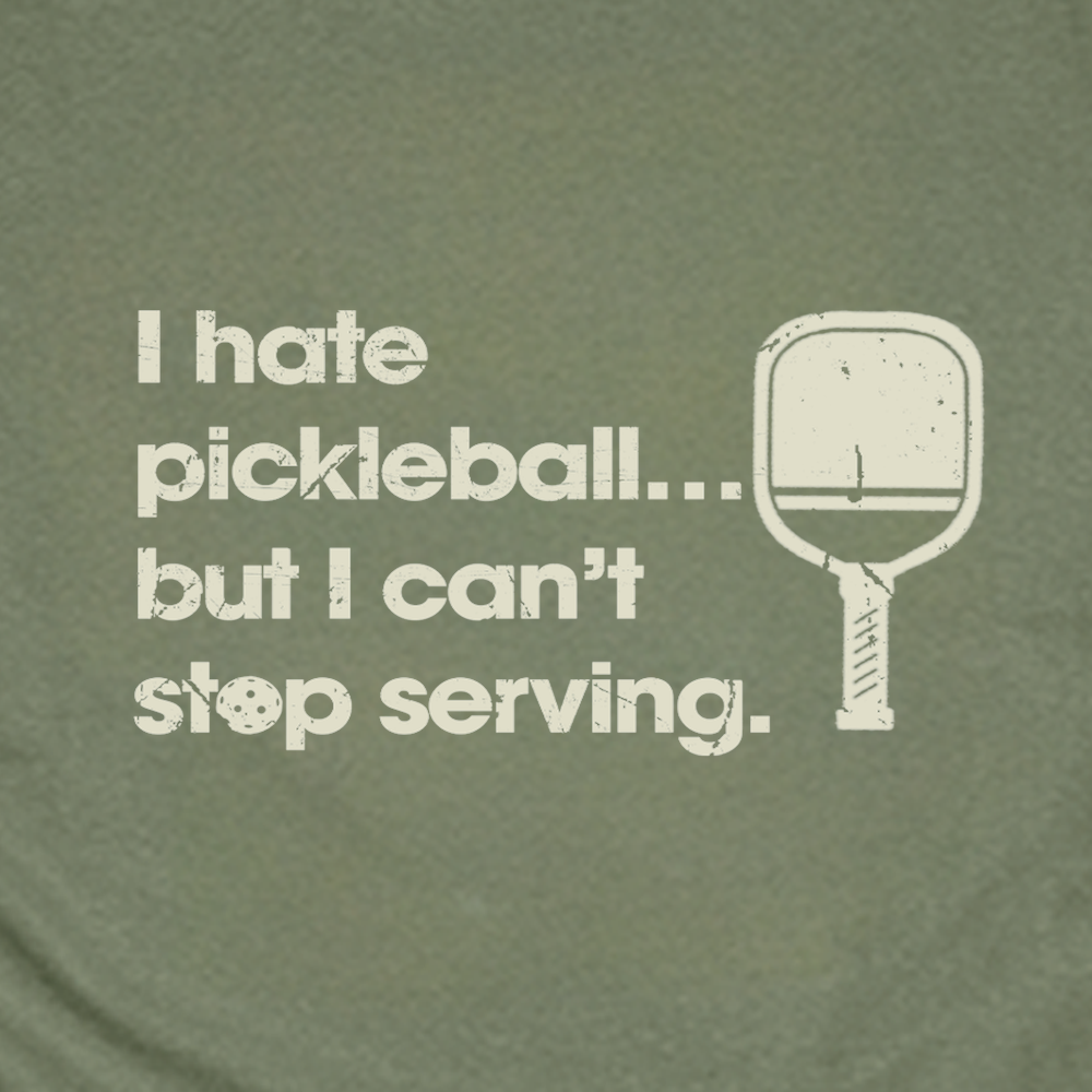 Green t-shirt with pickleball-themed text and graphics on a white background