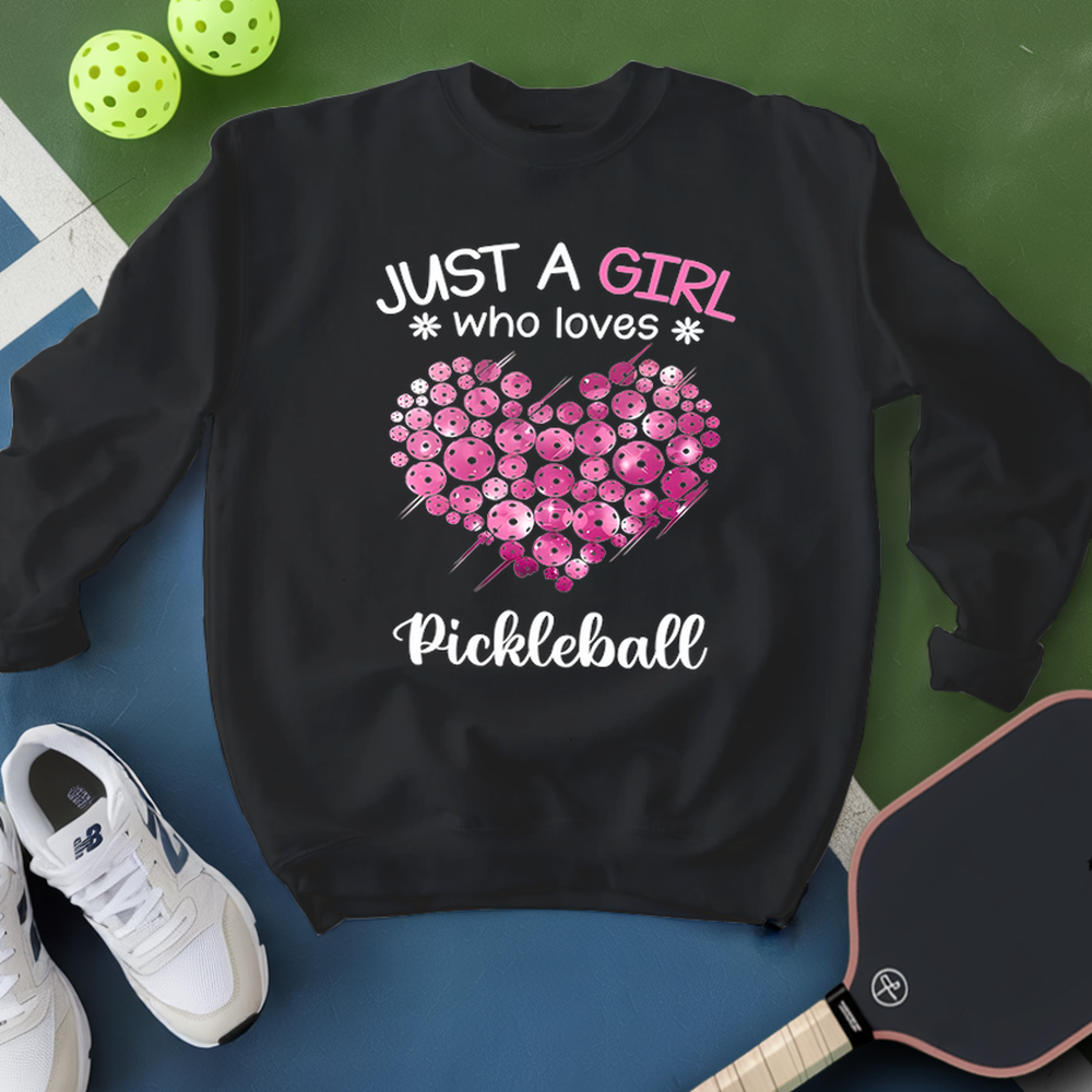 Black sweatshirt with pink floral heart design and text 'Just a girl who loves Pickleball' on a green and blue background.