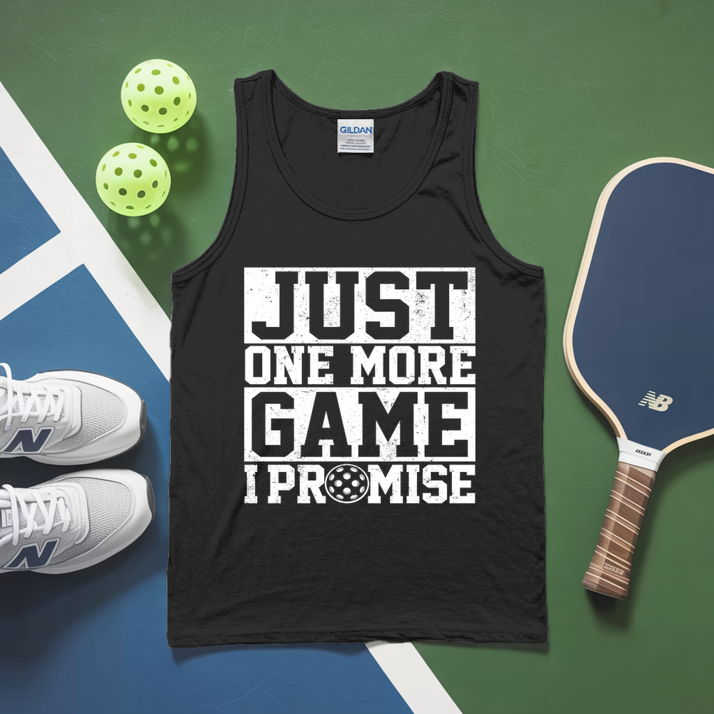 Black tank top with 'Just One More Game I Promise' text, pickleball paddles, and balls on a green and blue surface.