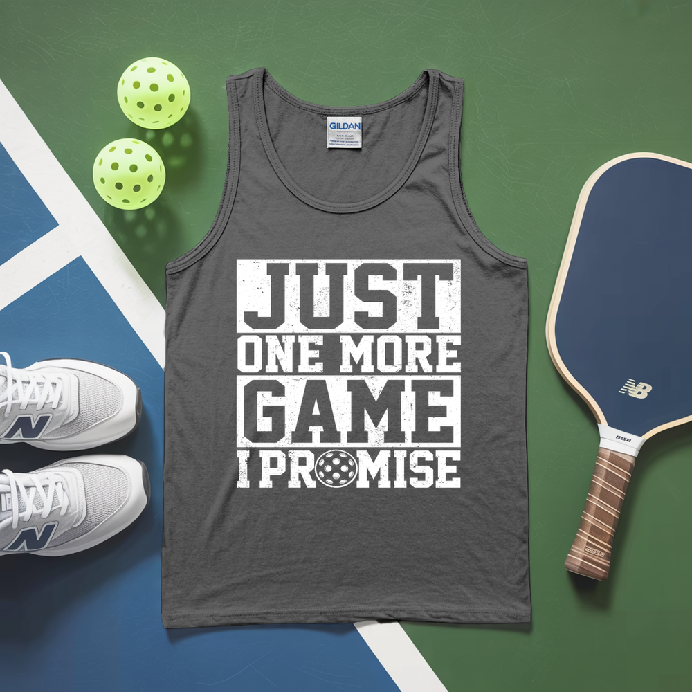 Gray tank top with 'Just One More Game I Promise' text, pickleball paddles, and balls on a green and blue surface.